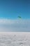 Kiteboarder with kite on the snow covered lake