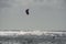 A kiteboarder or paraborder sails on the cornish waves. UK