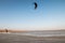 Kiteboarder pulling tricks and getting air on a bright summers day with perfect clear blue sky`s. Shingle Strret, Suffolk, UK