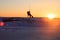 Kiteboarder sportsman under sunset sun, freestyle kiteboarding rider on the evening kitesession, sunset in the snow mountains,
