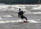 Kiteboarding on coastline of sea in storm