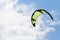 Kiteboarding kite close-up blue sky with clouds in background.