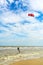 Kiteboarding. A kite surfer rides the waves. Holidays on nature.