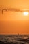 Kiteboarding kitesurfing kiteboarder kitesurfer kites silhouette in the ocean on sunset