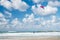 Kiter with blue red kite in Tel Aviv beach and blue sky