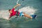 Kiter makes the difficult trick on a beautiful background. Kitesurfing Kiteboarding action photos man among waves