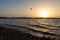 Kiters gliding over the Red sea surface. Extreme outdoor sport/activity/recreation. People in sport equipment riding on the water