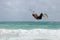 Kitesurfer jumping wave