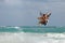 Kitesurfer jumping waves