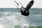 Kitesurfer jumps over the water.