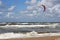 Kitesurfer passing by in the surf.