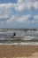 Kitesurfer passing by in the surf.