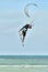 A kitesurfer performing an aerial trick.