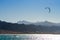 Kitesurfer rides in the Red Sea on the background of a rocky coast in Egypt Dahab South Sinai