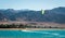 Kitesurfer rides in the Red Sea on the background of a rocky coast in Egypt Dahab South Sinai