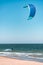 Kitesurfer swimming on an ocean or sea near beach