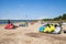 Kitesurfers on the beach prepare sport equipment