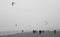 kitesurfers at sea suring a storm at a dutch beach