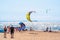 Kitesurfing is an extreme sport. The competitions of kite surfers. Bright colored paragliders on the beach. Saint-Petersburg.