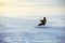 Kiting on a snowboard on a frozen lake