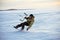 Kiting on a snowboard on a frozen lake