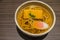 Kitsune Udon Japanese noodles in white bowl on wooden table