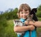 Kitten on arm of the boy outdoors, child huge his love pet