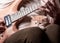 Kitten lays on man\'s lap who playing a guitar