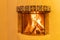 Kiva style fireplace burning logs