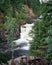 Kivach Falls, Karelia. Beautiful waterfall in the wild Northern nature among coniferous trees