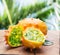 Kiwano fruits on the wooden table with green nature