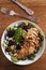 Kiwi blackberry balsamic chicken salad with avocado, spinach, feta cheese and walnuts.