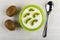 Kiwi, bowl with cottage cheese, slices of kiwi fruits, spoon on table. Top view