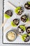 Kiwi Coved In Chocolate with Shredded Coconut and Nuts on a Stick, Healthy Snack on Bright Background