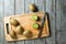 KIwi fruit on cutting board and knife on wooden background.