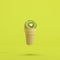 Kiwi fruit in ice-cream cone floating on green background