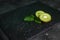 Kiwi and mint leaves on dark background, chia seeds