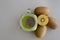 Kiwi smoothie with chia in mason jar on gray background with kiwis.Healthy food ,diet concept with spinach, pineapple, kiwi and