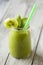 Kiwi smoothies in jar with straws