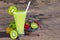 Kiwi yogurt smoothies juice,beverage healthy the taste yummy In glass drink episode morning on wood background.