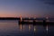 Klaipeda city, Lithuania in January. A lonely small lighthouse in front of dark sunset sky