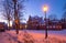 Klaipeda, Lithuania - 01 15 21: Old historical Neo-Gothic University building campus in winter snow, pink sunset colors and city