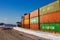 Klaipeda, Lithuania - 02 06 21: colored cargo export container in the warehouse of Klaipeda port docks, yellow crane and