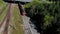 Klaipeda, Lithuania - 17 may 2021: Aerail view,  train with attached wagons passes under the bridge.