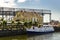 Klaipeda, Lithuania - Juny 24, 2021: Beautiful view on tourist boat, Dane river, embankment and yellow brick houses Klaipeda, Lith