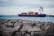 KLAIPEDA, LITHUANIA - November 24, 2019: Sea gate of Klaipeda harbour. The containership leaving the harbour to the sea