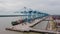 Klang, Malaysia - October 09, 2022: Cranes at the port Klang near Kuala Lumpur. Container crane at Klang Harbor. Aerial view on a