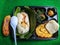 Klaten, 19 March 2021. a food package in the form of grilled rice, corn bakwan, papaya vegetable, and a banana.