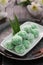 Klepon or kelepon, is a snack of sweet rice cake balls filled with molten palm sugar and coated in grated coconut.