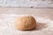 Kneaded dough ball from rye flour on marble countertop ready to go in oven